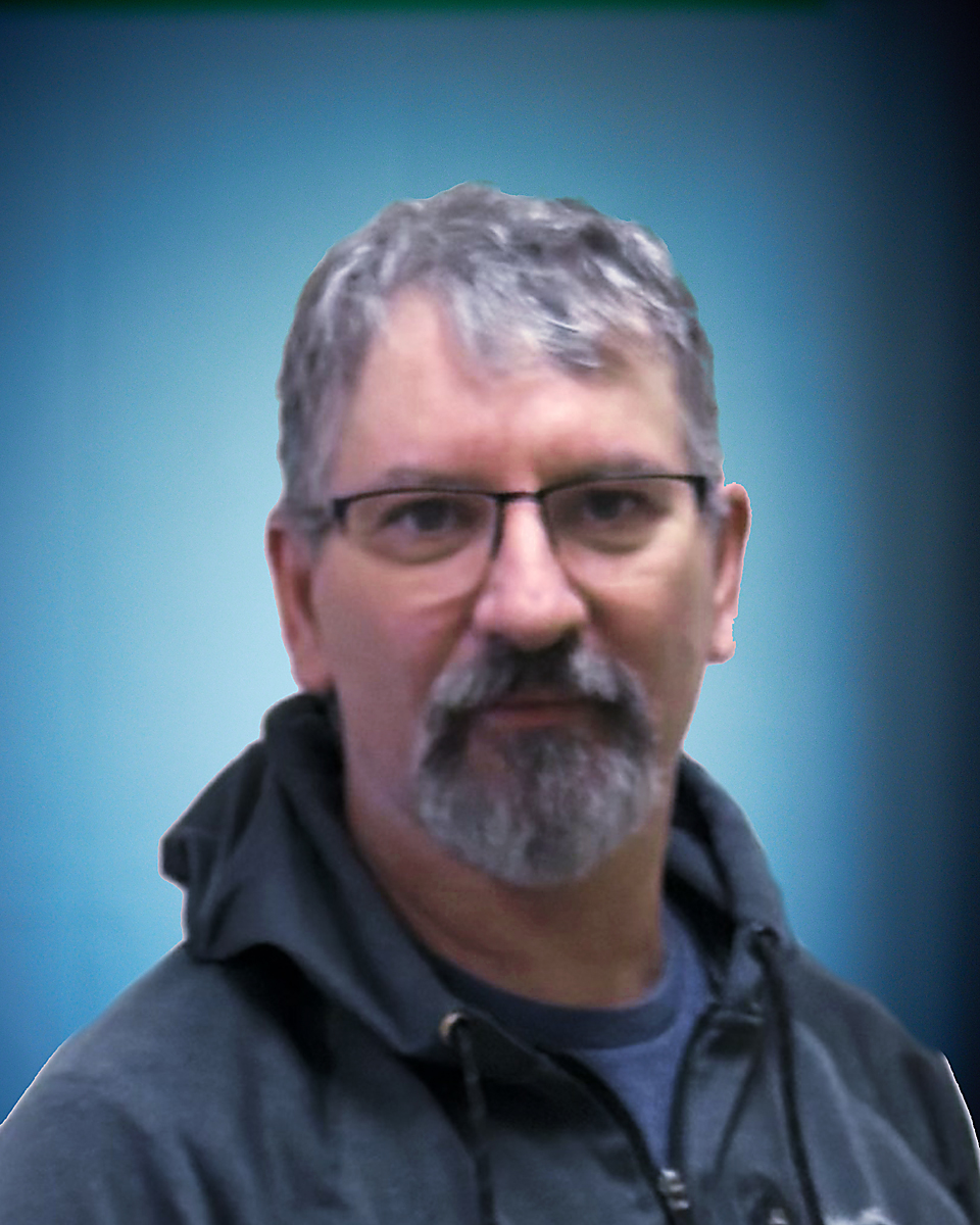 Man with glasses, gray hair, wearing hoodie